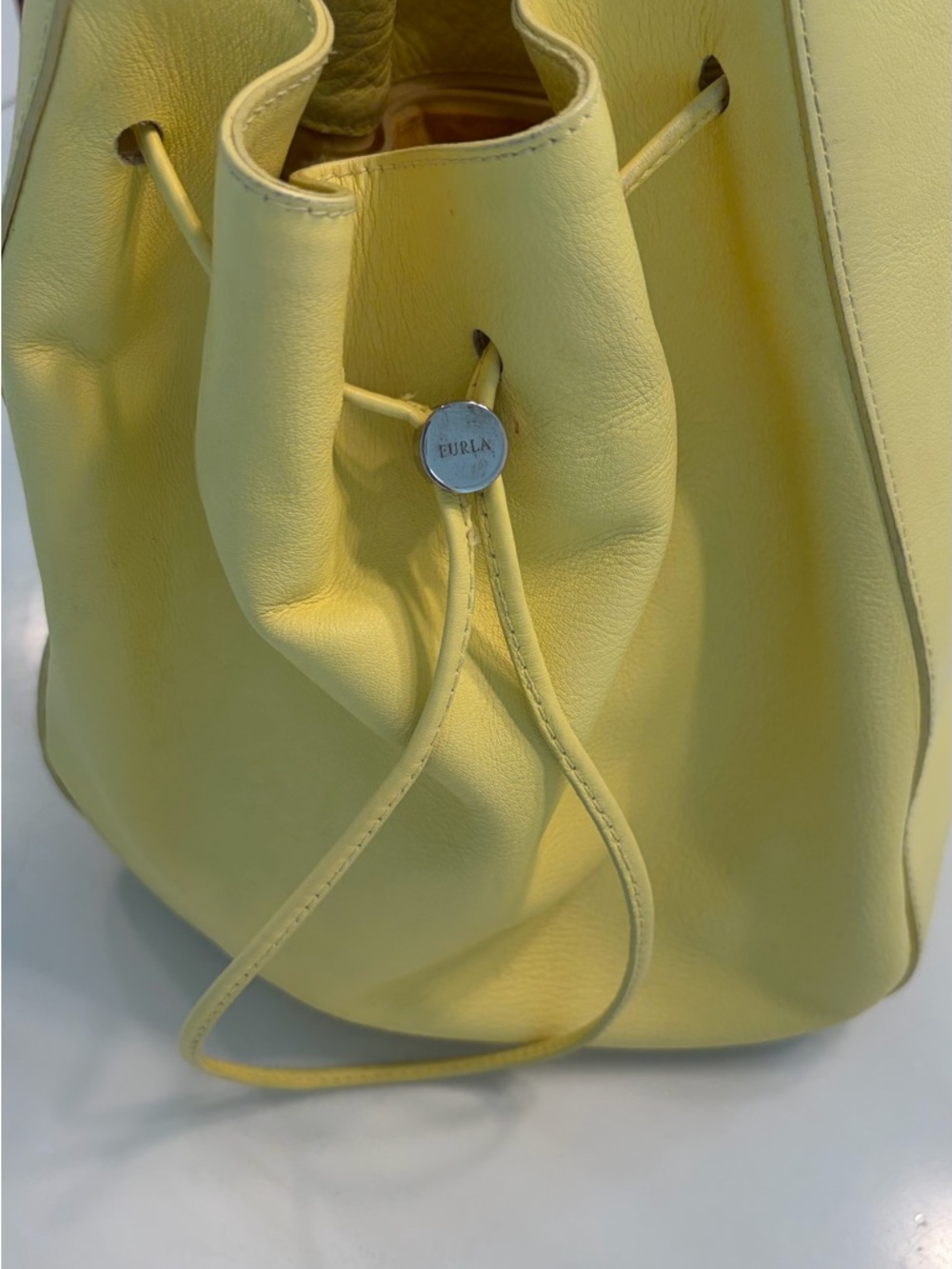 Furla soft yellow drawstring bucket style purse with nickel hardware